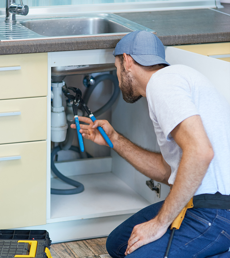 Plumber Fixing Broken Sink